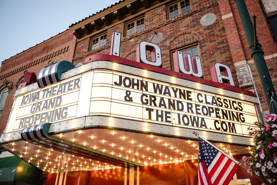 Iowa Theater sign lit up at night for its grand reopening.